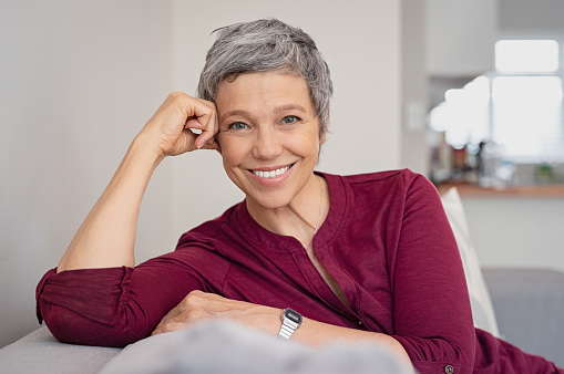 A smiling woman with dental crowns